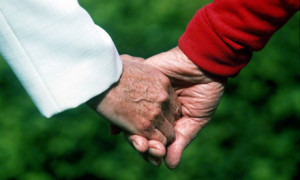 An older couple holding hands